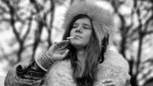 Janis Joplin, posed, smoking cigarette (Photo by Jan Persson/Redferns)